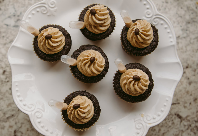 Fancy white plate with chocolate cupcakes with pipettes filled with alcohol