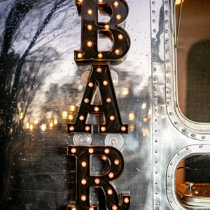 Light up bar sign on side of Airstream mobile bar