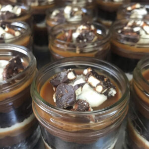 Mason jars filled with chocolate and caramel dessert