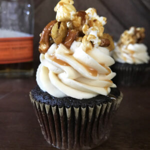 Chocolate cupcake with vanilla frosting and caramel popcorn topping