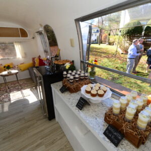 Interior of airstream mobile bakery with cake pops and cupcakes