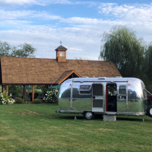 Airstream mobile bar set up in front of pavilion at event