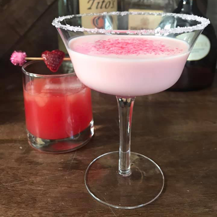 Pale pink strawberry cocktail with sugar rim on the glass